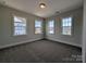 Bright bedroom showcasing three large windows and neutral carpet at 267 Luray Way # 445, Rock Hill, SC 29730