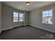 Well-lit bedroom with plush carpeting and multiple windows offering neighborhood views at 267 Luray Way # 445, Rock Hill, SC 29730