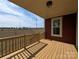 View of the wood porch with handrails, painted red siding, white trim, and view of the surrounding area at 267 Luray Way # 445, Rock Hill, SC 29730