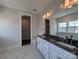 Bathroom featuring double sinks, a large mirror, and a view of a closet with ample storage at 275 Luray Way # 447, Rock Hill, SC 29730