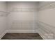 Walk-in closet featuring custom shelving, and wood flooring at 275 Luray Way # 447, Rock Hill, SC 29730