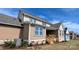 Exterior view of a brown two story home with a covered patio, blue window trim, and stairs leading to the yard at 275 Luray Way # 447, Rock Hill, SC 29730