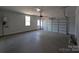 Spacious two-car garage with concrete floor, storage, window, and access door at 275 Luray Way # 447, Rock Hill, SC 29730