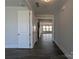 Open hallway with dark wood flooring leading to the living area and staircase at 275 Luray Way # 447, Rock Hill, SC 29730