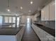 Open kitchen featuring white cabinets, stainless steel appliances, and a large island with seating at 275 Luray Way # 447, Rock Hill, SC 29730