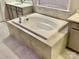 Bathroom featuring a soaking tub with tile surround and vanity with stone countertops at 278 W Waterlynn Rd, Mooresville, NC 28117