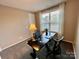 Neutral carpeted room with a window, desk and a black adjustable height desk at 278 W Waterlynn Rd, Mooresville, NC 28117