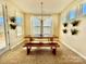 Inviting dining area with a classic wooden table, bench seating, and abundant natural light at 278 W Waterlynn Rd, Mooresville, NC 28117