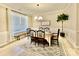 This dining room features a large window for natural light and a stylish black spindle dining set at 278 W Waterlynn Rd, Mooresville, NC 28117