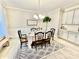 Elegant dining room with a decorative light fixture, wainscoting, and a view of the backyard at 278 W Waterlynn Rd, Mooresville, NC 28117