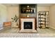 A tiled fireplace is flanked by decorations and a leafy plant at 278 W Waterlynn Rd, Mooresville, NC 28117