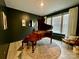 This piano room features dark walls and a beautiful piano at 278 W Waterlynn Rd, Mooresville, NC 28117