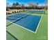 Well-maintained tennis court with vibrant blue and green surfaces, ready for recreational play at 278 W Waterlynn Rd, Mooresville, NC 28117