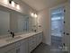 Bathroom boasts dual sinks, white cabinetry, and sleek black fixtures for a modern appeal at 279 Luray Way # 448, Rock Hill, SC 29730