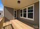 Inviting outdoor deck with wood floors and an exterior wall with multiple bright windows at 279 Luray Way # 448, Rock Hill, SC 29730