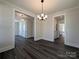 Open dining room with modern chandelier, dark floors, and easy access to other living spaces at 279 Luray Way # 448, Rock Hill, SC 29730