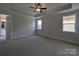 Inviting main bedroom with tray ceiling, dual windows, carpet flooring, and neutral walls at 279 Luray Way # 448, Rock Hill, SC 29730