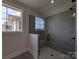 Modern shower with gray tiles, a glass door, and a window offering natural light at 279 Luray Way # 448, Rock Hill, SC 29730