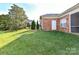 Spacious backyard with green grass near a brick home at 2802 Santiago Cir, Monroe, NC 28110