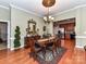 Traditional dining room featuring hardwood floors, elegant chandelier and access to the kitchen at 2802 Santiago Cir, Monroe, NC 28110