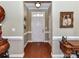 Bright foyer featuring hardwood floors, neutral walls, and elegant decor leading into the home at 2802 Santiago Cir, Monroe, NC 28110