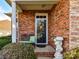 Inviting front porch with stone accents, a wrought-iron bench, and charming decorative elements at 2802 Santiago Cir, Monroe, NC 28110