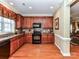 Kitchen featuring updated cabinets, stainless steel appliances, hardwood flooring and tile backsplash at 2802 Santiago Cir, Monroe, NC 28110