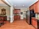 Open kitchen area with updated stainless steel appliances, view of dining area and hardwood floors at 2802 Santiago Cir, Monroe, NC 28110