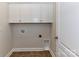 Laundry area with white cabinets and tile flooring at 2802 Santiago Cir, Monroe, NC 28110