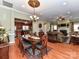 Open concept living space with a view of dining area, kitchen, fireplace, and hardwood flooring at 2802 Santiago Cir, Monroe, NC 28110