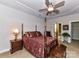 Main bedroom with tray ceiling, ceiling fan, furniture, and four-poster bed at 2802 Santiago Cir, Monroe, NC 28110