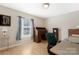 Cozy bedroom featuring a classic wooden desk, ample natural light, and neutral wall paint at 3080 Sims Rd, Rock Hill, SC 29730