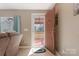 A view of the front door and red porch through the doorway of a neutrally painted living room at 3080 Sims Rd, Rock Hill, SC 29730