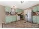 Well-lit kitchen with sleek appliances, tiled floor, and charming mint green cabinets at 3080 Sims Rd, Rock Hill, SC 29730