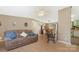 Inviting living room featuring a comfortable couch, light wood floors, and a view into the kitchen and dining areas at 3080 Sims Rd, Rock Hill, SC 29730