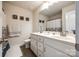 Well-lit bathroom with a double sink vanity, tiled floors, and decor accents for a modern appeal at 317 Praline Way, Fort Mill, SC 29715