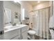 Clean bathroom with a white vanity, bathtub, and shower with patterned curtain at 317 Praline Way, Fort Mill, SC 29715