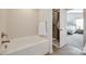 Bathroom showcasing a white tub, tiled shower with a glass door, and neutral walls at 317 Praline Way, Fort Mill, SC 29715