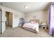 Bedroom with neutral carpet, natural light, and pink accents with open door to another room at 317 Praline Way, Fort Mill, SC 29715