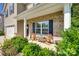 Inviting front porch with chairs and a table, perfect for relaxing at 317 Praline Way, Fort Mill, SC 29715