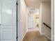 Bright hallway with carpet flooring leading to various rooms, including a bathroom at 317 Praline Way, Fort Mill, SC 29715