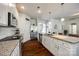 Bright, modern kitchen with granite countertops, island, and stainless steel appliances at 317 Praline Way, Fort Mill, SC 29715