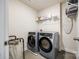 Well-organized laundry room with modern washer and dryer set and ample storage shelving at 317 Praline Way, Fort Mill, SC 29715