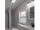 Contemporary bathroom with gray walls, decorative vanity mirrors, modern fixtures, and tiled shower at 35494 Dry Rd, Albemarle, NC 28001