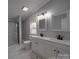 Bright bathroom with a double sink vanity, modern fixtures and marble-look tile in the shower and flooring at 35494 Dry Rd, Albemarle, NC 28001