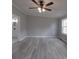 This modern bedroom showcases neutral walls, sleek flooring, a ceiling fan, and access to an ensuite bathroom at 35494 Dry Rd, Albemarle, NC 28001