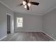 Comfortable bedroom with light gray walls, modern flooring, and a ceiling fan for temperature control at 35494 Dry Rd, Albemarle, NC 28001