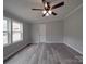 Spacious bedroom featuring light gray walls, wood-look flooring, and a ceiling fan for added comfort at 35494 Dry Rd, Albemarle, NC 28001