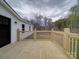 A spacious wooden deck complete with railing, offers a great spot for relaxation with a view at 35494 Dry Rd, Albemarle, NC 28001