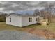 A view of the house from the side shows a spacious wooden deck and a gravel-covered area at 35494 Dry Rd, Albemarle, NC 28001